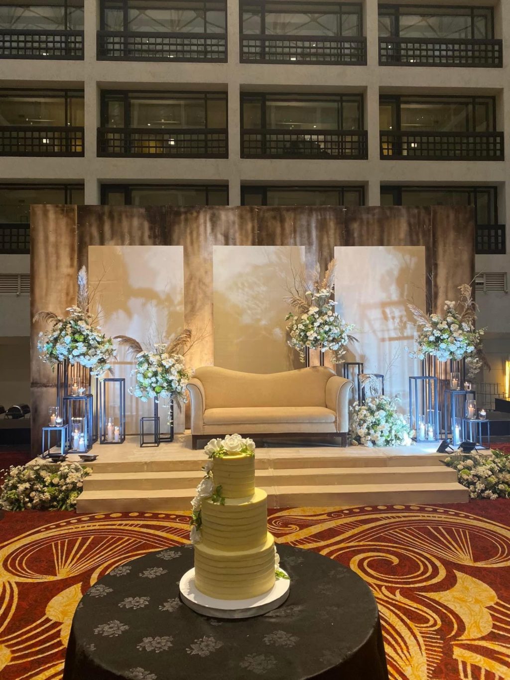 Settee back stage with a three-tier wedding cake